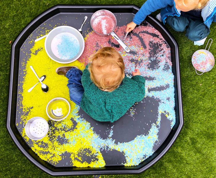 children playing with kinetic sand on large tuff tray