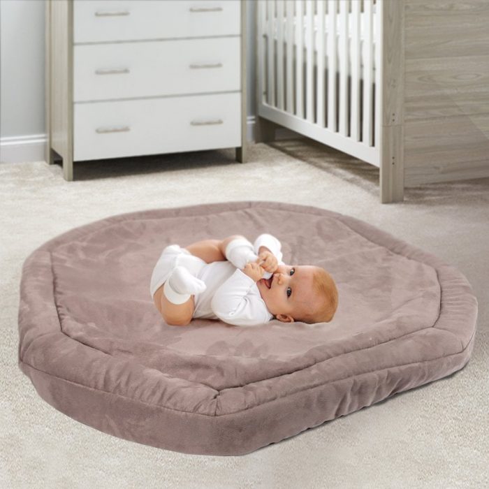 child laying on tuff tray plush mat