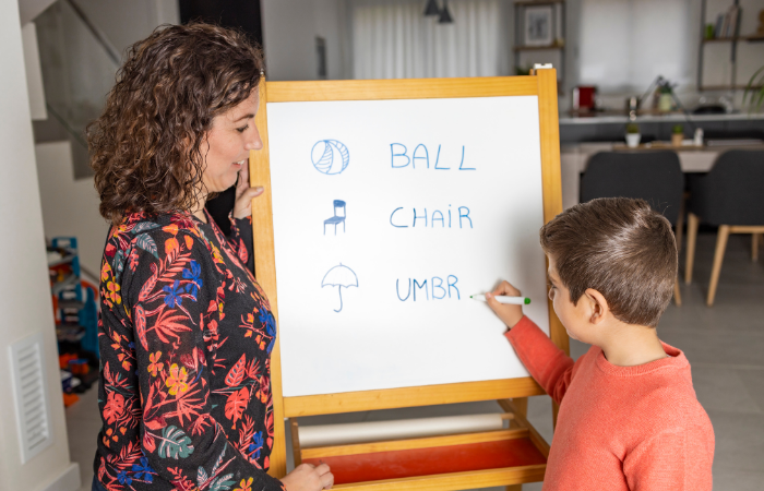 child identifying objects using whiteboard