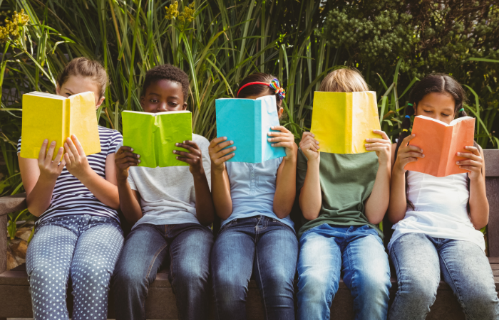 children sitting together reading books