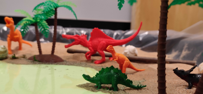 plastic dinosaur figures in dinosaur themed tuff tray