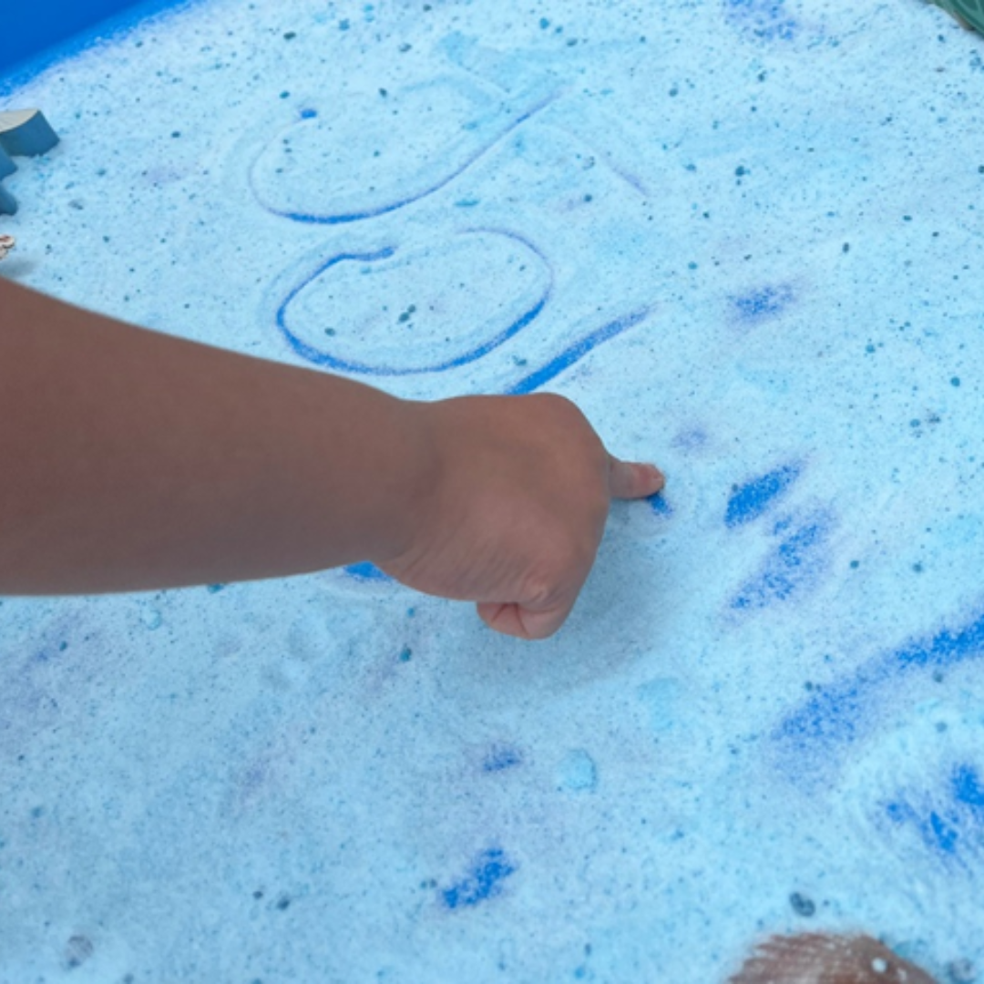 child writing name in foam