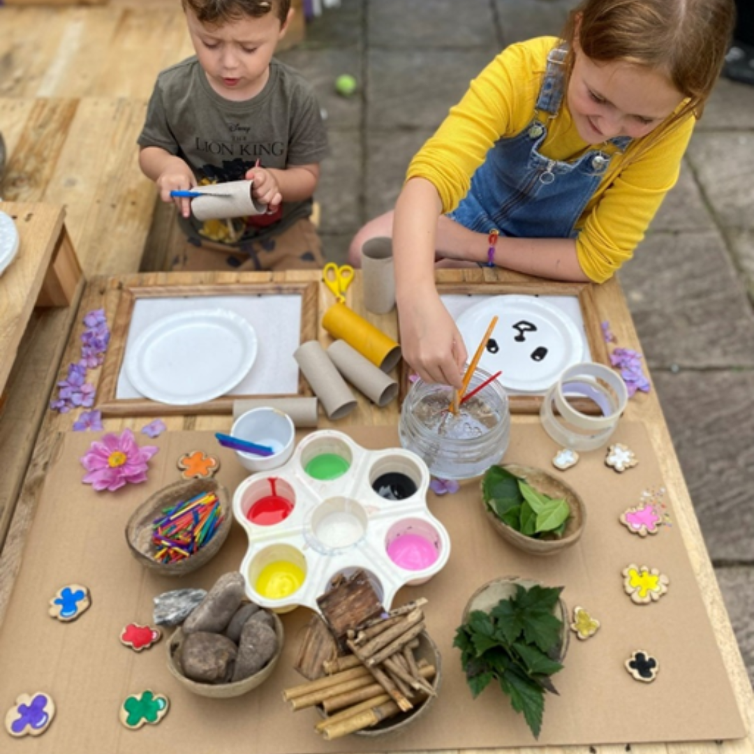 two children painting outdoors