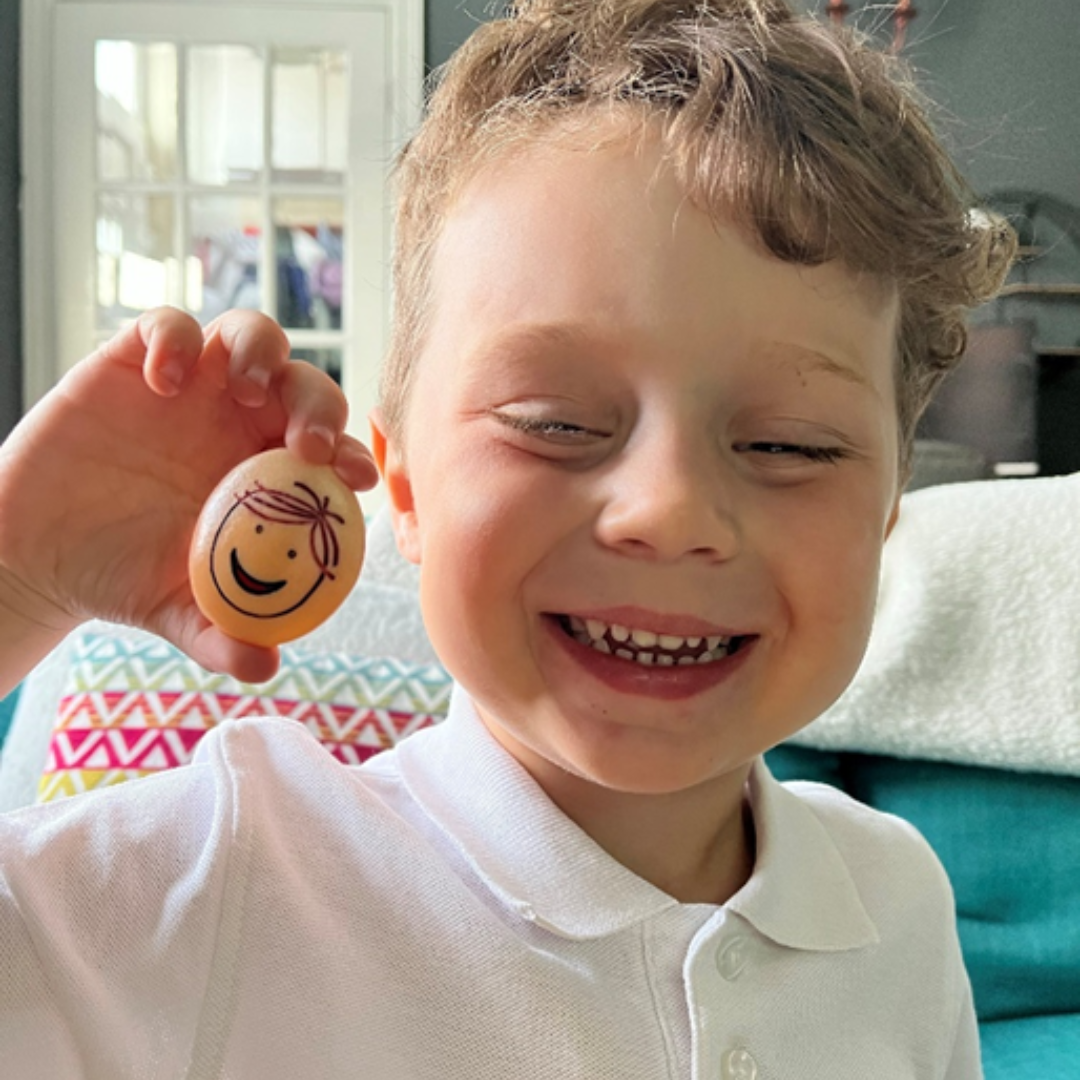 child smiling with a happy emotions stone