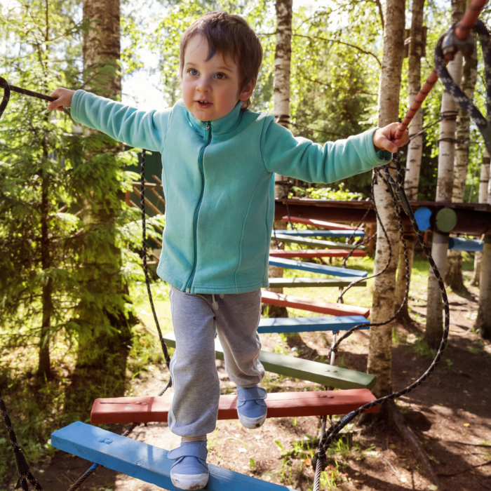 child going through obstacle course