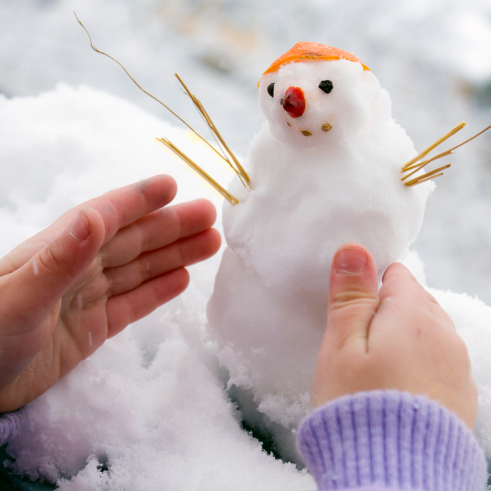 child building snowman