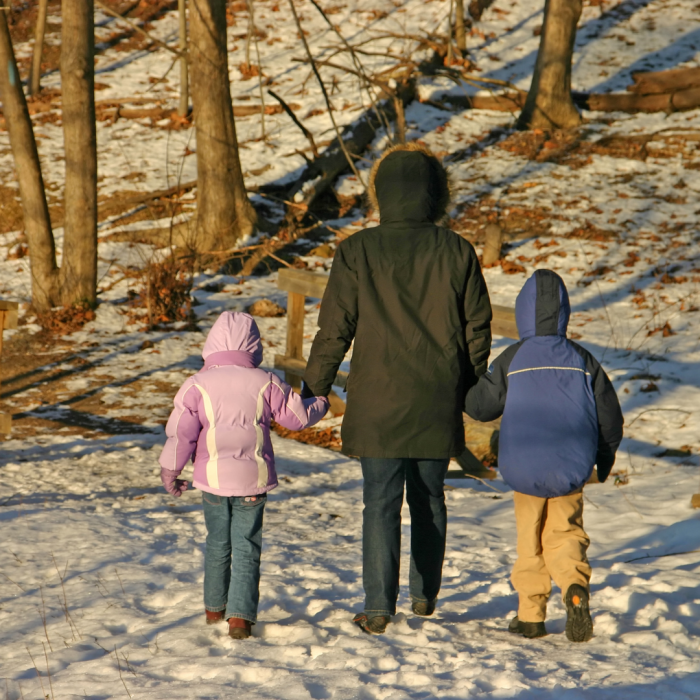 parent taking children for a scavenger hunt outdoors