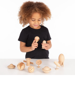 child playing with wooden planets