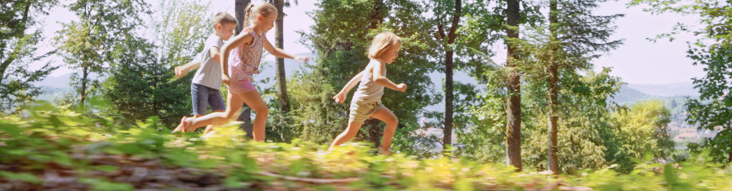 children running through the forest