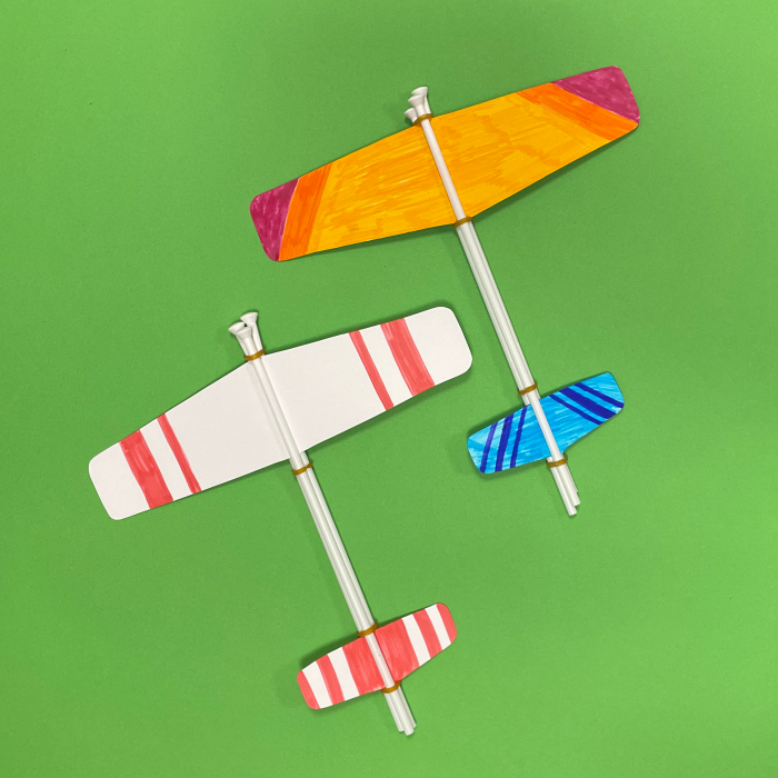 two paper planes on green background