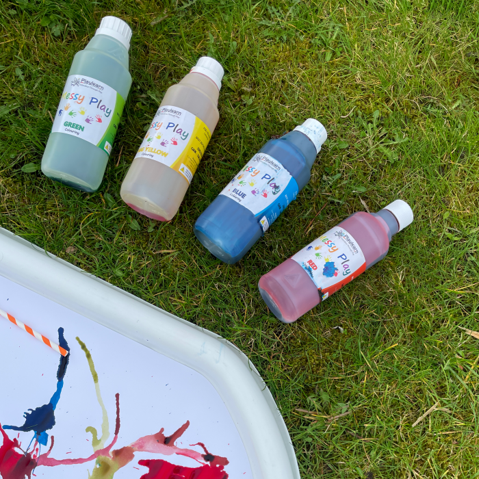 tuff tray with paper pad next to paint bottles